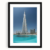 Colorful abstract art print of Burj Khalifa, featuring vibrant blue and orange tones on a large framed canvas.