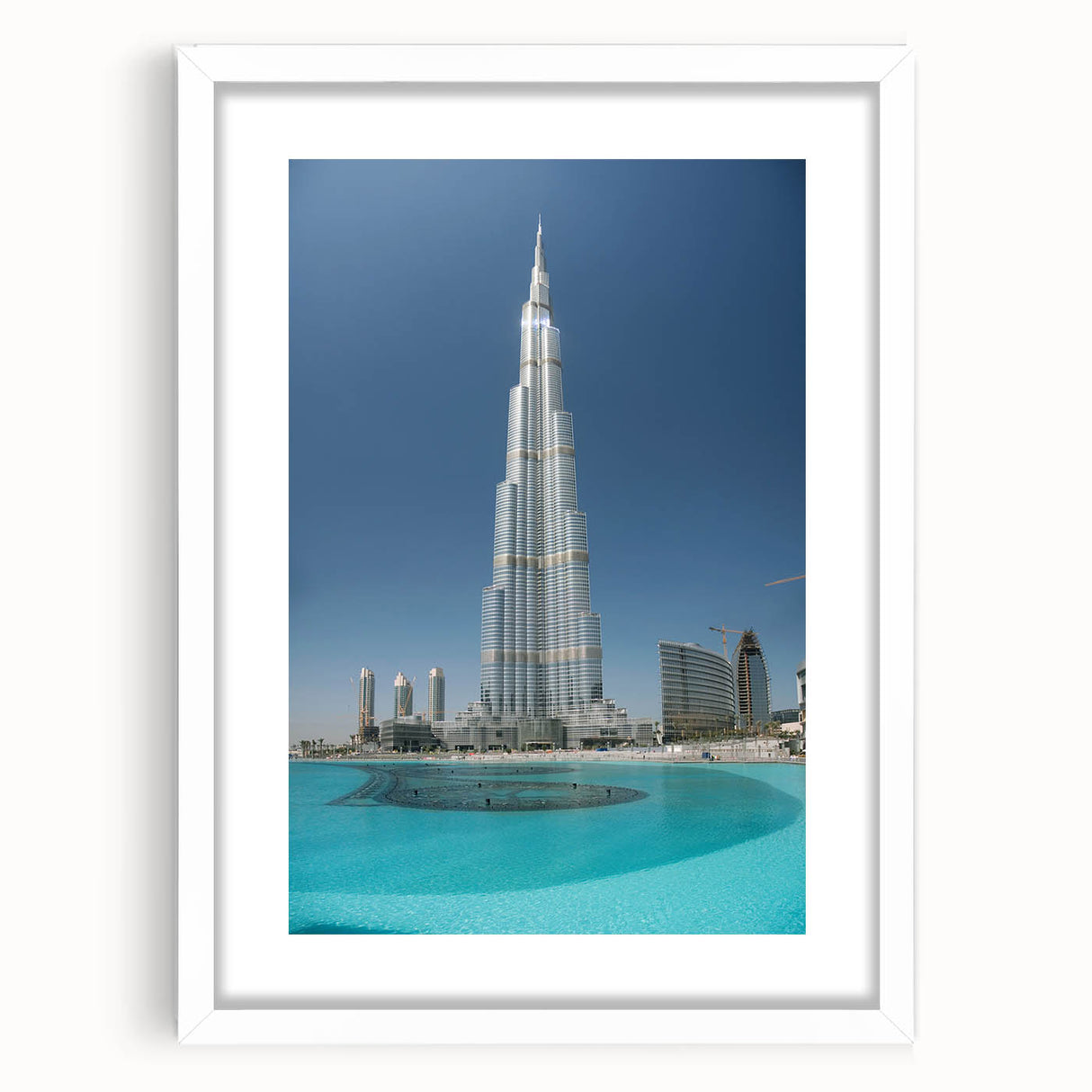 Abstract art print of Burj Khalifa in muted gray and blue tones on a white matted frame.