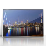 Mid-century modernist art of Auckland skyline in muted gray and blue tones on a white framed acrylic.