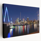 Side view of a stretched canvas featuring Auckland's skyline in muted blue and gray tones, ideal for kitchen wall art.