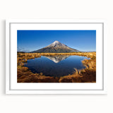 Abstract art print of Taranaki in New Zealand with muted blue and green tones on a white framed canvas.