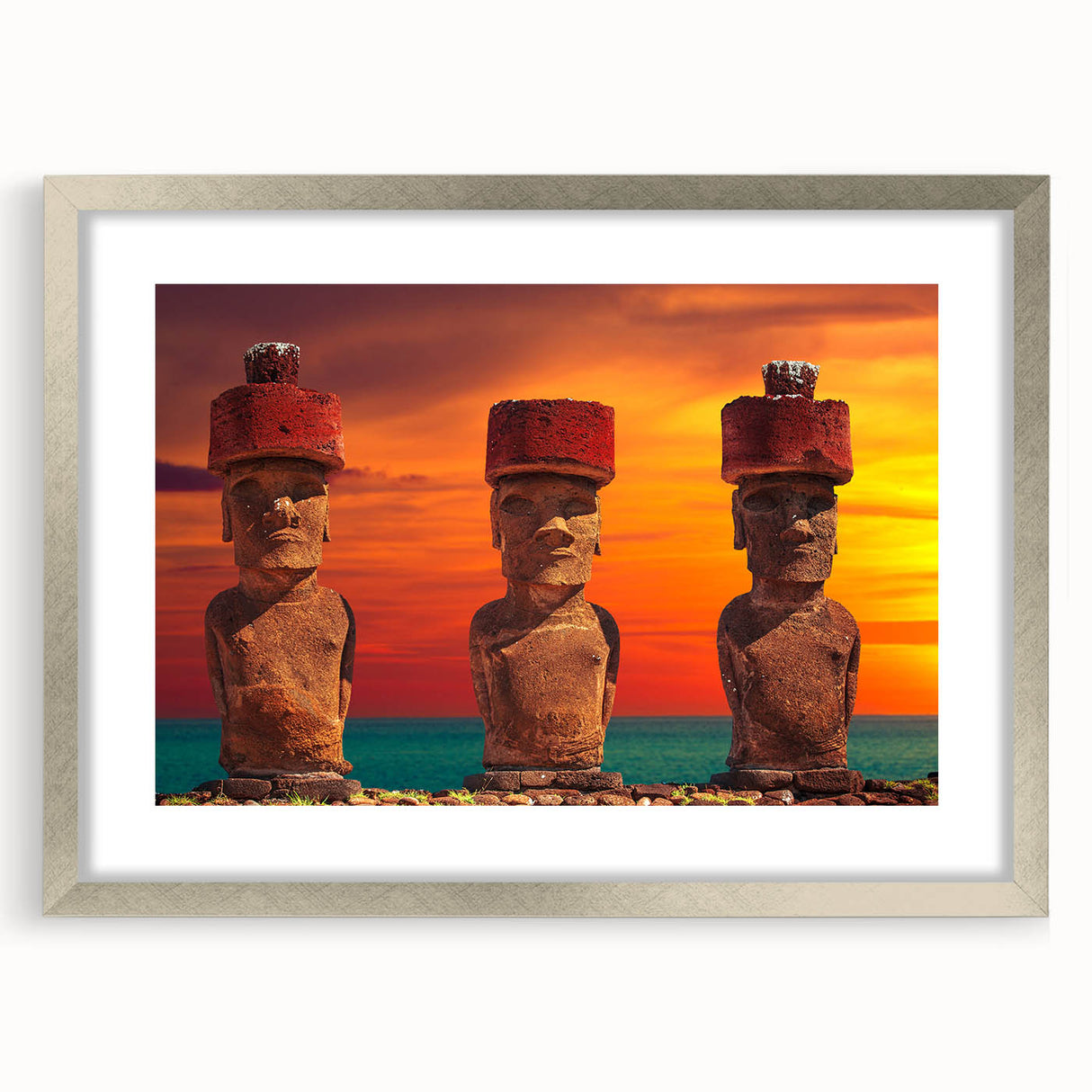 Textured art print of Easter Island statues in muted earth tones on a framed silver mat, suitable for bedroom decor.