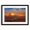 Colorful abstract art print of Monument Valley in vibrant shades on a large textured canvas, framed in black.