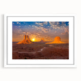 Abstract art print of Monument Valley with muted earth tones on a white framed mat, suitable for dining room decor.