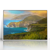 Acrylic print of Big Sur coastline in muted earth tones, framed in white, suited for modern nursery decor.