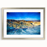 Textured art depicting abstract Death Valley scenery in muted earth tones on a silver-framed mat, suitable for bedroom decor.