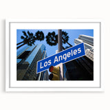 Abstract art print of Los Angeles skyline in muted gray and blue tones, framed with a white mat.