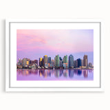 Abstract art print of San Diego skyline in muted blue and gray tones, framed with a white mat.