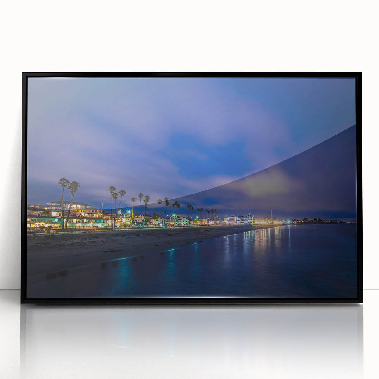 Large abstract wall art depicting the Santa Cruz coastline in muted blue and green tones, framed in black acrylic.