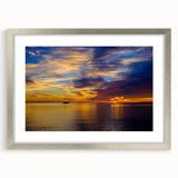 Textured art print of abstract Florida Keys scenery in muted blue and green, framed in silver, ideal for bedroom decor.