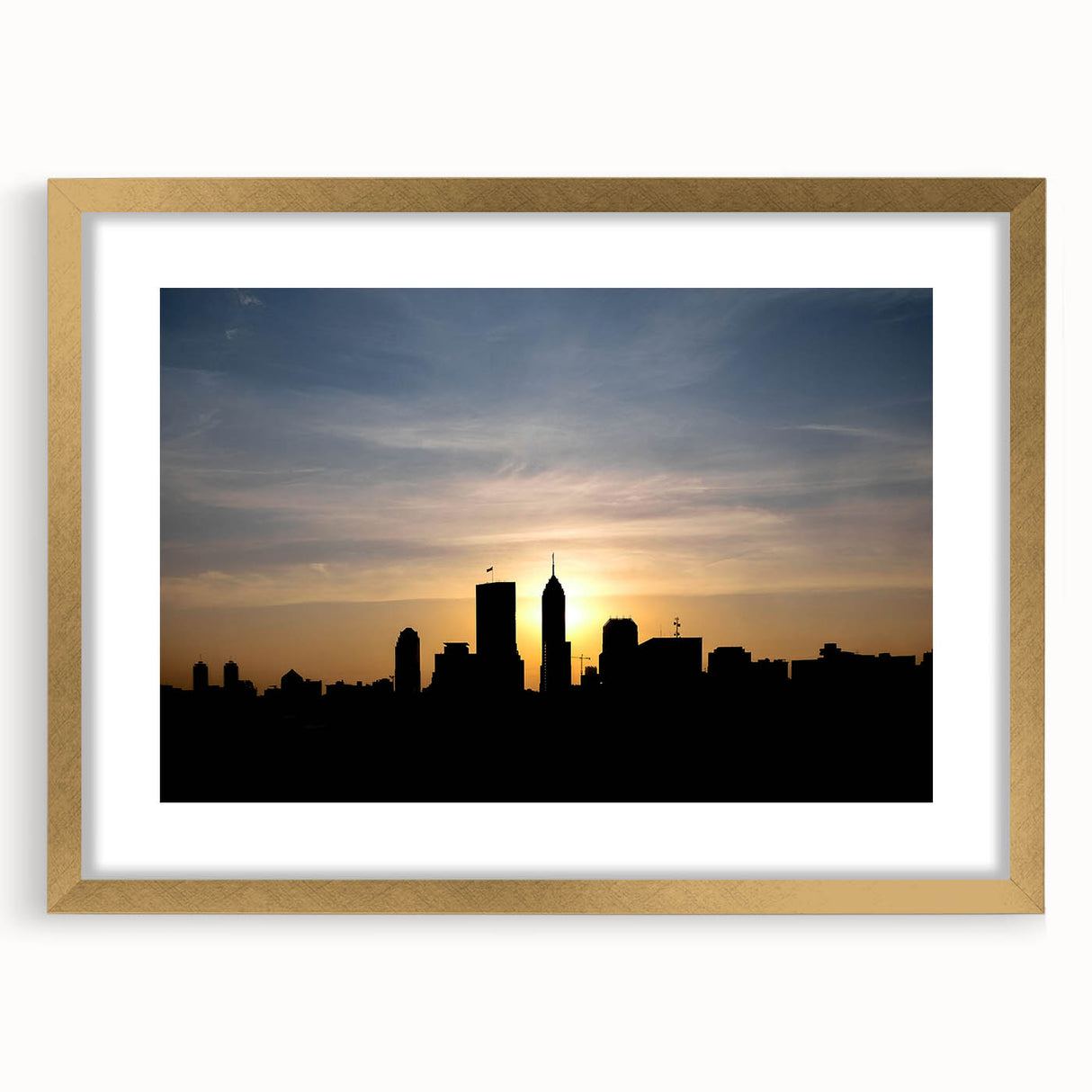 Extra large abstract art print of Indianapolis skyline in muted gray and blue tones, framed in gold.