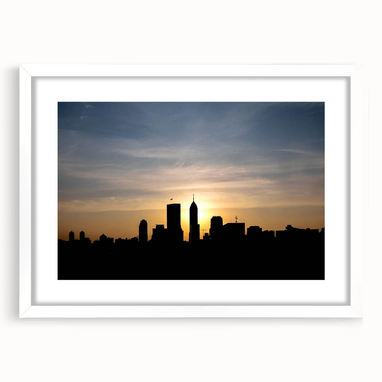 Abstract art print of Indianapolis skyline in muted gray and blue tones on a white framed canvas.