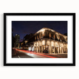Colorful abstract art print of New Orleans scenery, in a black frame with mat, ideal for living room decor.