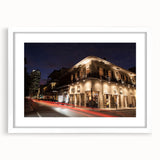 Abstract art print of New Orleans with muted blue and purple tones on a framed white mat, ideal for dining room decor.