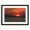 Colorful abstract art print of Annapolis scenery in vibrant hues on a black framed mat, ideal for living room decor.