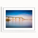Abstract art print of Baltimore skyline in muted gray and blue tones on a framed white mat, suitable for dining room decor.