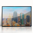 Large abstract wall art depicting Kansas City skyline in muted gray and blue tones on acrylic, framed in black.