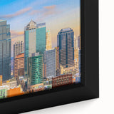 Textured black wall art depicting the Kansas City skyline in vibrant colors on a framed canvas.