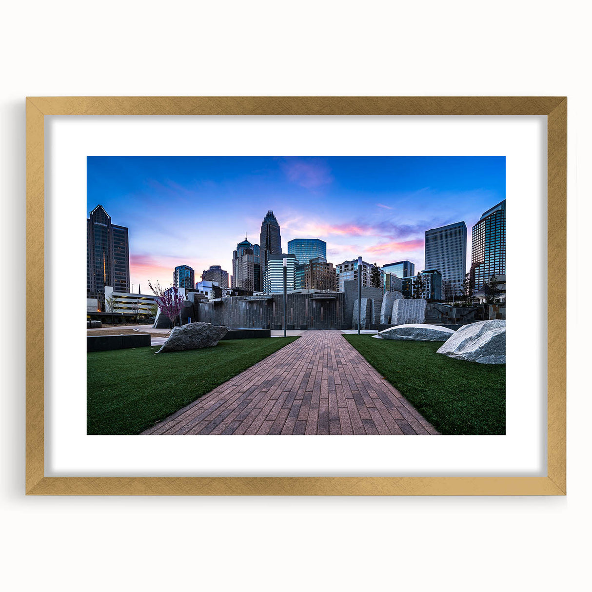 Extra large abstract art print of Charlotte skyline in muted gray and blue tones, framed in gold.