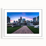 Abstract art print of Charlotte skyline in muted gray and blue tones on a white framed poster, ideal for dining room decor.