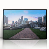 Large abstract wall art depicting the Charlotte skyline in muted gray and blue tones on a framed acrylic.
