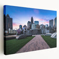 Side view of a stretched canvas depicting the Charlotte, North Carolina skyline in muted blue and gray tones.