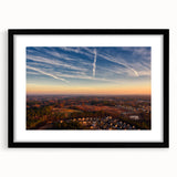 Abstract art print of colorful, textured scenery, displayed in a black frame with mat, ideal for living room decor.