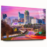 Large abstract wall art of Raleigh skyline in muted blue and green tones on acrylic glass.