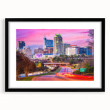 Abstract art print of a colorful, textured Raleigh skyline on a large canvas, framed in black.