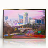 Large art print of Raleigh, North Carolina skyline in mid-century modernist style with gold acrylic frame.