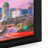 Framed canvas of a textured Raleigh skyline in black with colorful accents, ideal for a living room.