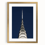 Extra large framed wall art featuring an abstract depiction of the Chrysler Building in textured gold and black tones.