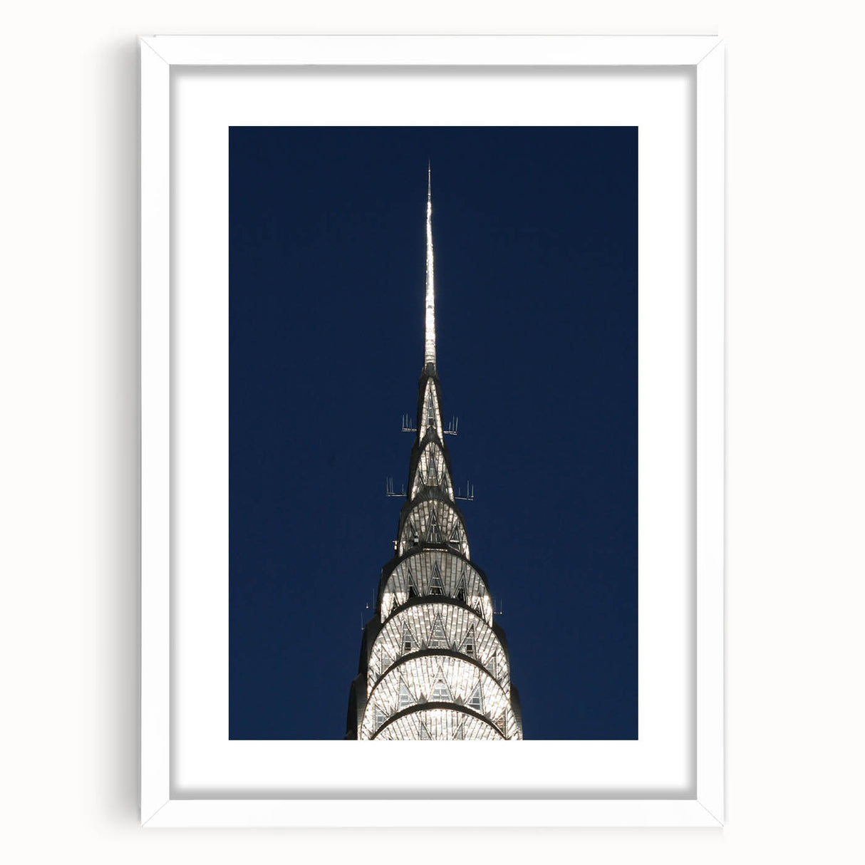 Abstract art print of the Chrysler Building in muted gray tones on a framed white mat.