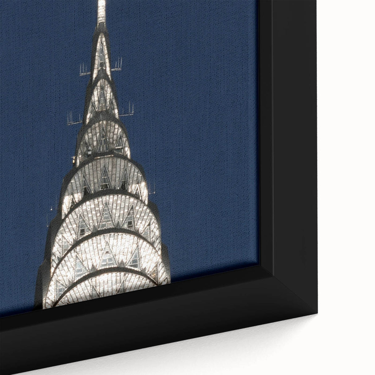 Close-up of a black wall art featuring the Chrysler Building, with textured, colorful accents on a framed canvas.
