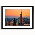 Extra large abstract art print of NYC skyline in vibrant colors on a textured canvas, framed in black.