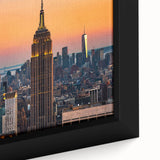 Close-up of a textured black wall art depicting NYC's Empire State, with colorful accents, on a large framed canvas.