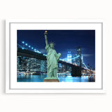 Abstract art print of the Statue of Liberty in muted gray and blue tones on a framed white mat.