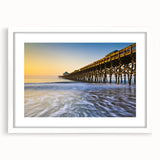 Abstract art print of Charleston scenery in muted blue and green tones, framed in white, suitable for dining room decor.