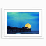 Abstract art print of South Carolina scenery in muted green and blue tones, framed in white, ideal for dining room decor.