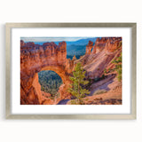 Textured art of Bryce Canyon in muted orange and red tones on a framed silver mat, suitable for bedroom decor.