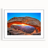 Abstract art print of Canyonlands with vibrant orange and red hues on a white framed mat, ideal for dining room decor.