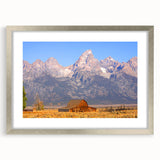 Textured art depicting the Grand Tetons in muted earth tones on a framed silver mat, suitable for bedroom decor.