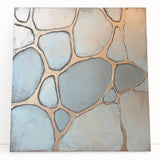 Abstract geometric stretched canvas artwork showcasing vibrant colors and dynamic shapes, leaning against a neutral wall, perfect for modern home decor.