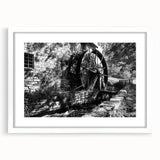 Abstract art print featuring swirling blue and gray patterns on a white framed canvas.