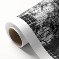 Art deco poster of a geometric building in monochrome tones on rolled canvas.