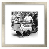 Textured abstract art print featuring indistinct human figures in cool gray tones, framed in silver, ideal for bedroom decor.