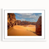 Extra large abstract art print of Algerian scenery in muted earth tones on a textured canvas, framed in white.