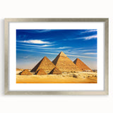 Abstract art print of Egyptian scenery in muted earth tones on a framed silver mat, suitable for dining room decor.