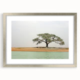 Abstract art print of African scenery in muted earth tones on a framed silver mat, suitable for dining room decor.