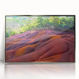 Acrylic print of a Mauritian landscape with silver frame, featuring vibrant green and blue tones.